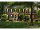 Charming two-story brick home with a well-manicured lawn and mature trees at 1261 Hawthorne Dr, Indian Trail, NC 28079
