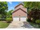 Spacious two-car garage with brick exterior and a concrete driveway at 1261 Hawthorne Dr, Indian Trail, NC 28079