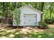 Detached garage with white siding and carriage doors, offering ample storage space at 1261 Hawthorne Dr, Indian Trail, NC 28079
