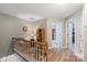 Well-lit upstairs hallway with hardwood floors and neutral wall color at 1261 Hawthorne Dr, Indian Trail, NC 28079