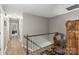 Upstairs hallway with hardwood floors and neutral wall color at 1261 Hawthorne Dr, Indian Trail, NC 28079