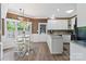 Bright kitchen with eat-in breakfast nook, white cabinets, stainless steel appliances, and granite counters at 1261 Hawthorne Dr, Indian Trail, NC 28079