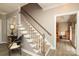 Elegant staircase with carpeted steps and white railings leading to the upper level at 1261 Hawthorne Dr, Indian Trail, NC 28079