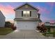 Charming two-story home with a two-car garage, landscaped garden, and vibrant red flowers accenting the facade at 1270 Winding Creek Rd, Salisbury, NC 28146