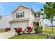 Charming two-story home with a two-car garage, landscaped garden, and vibrant red flowers accenting the facade at 1270 Winding Creek Rd, Salisbury, NC 28146