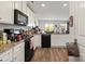 Bright kitchen with white cabinets, dark appliances, and wood flooring, providing a modern and welcoming cooking space at 1270 Winding Creek Rd, Salisbury, NC 28146