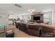 Bright and airy living room showcasing a large sectional, ceiling fan, and seamless flow to the dining and kitchen areas at 1270 Winding Creek Rd, Salisbury, NC 28146