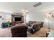 Cozy living room with a sectional sofa, ceiling fan, and entertainment center, perfect for relaxation and entertainment at 1270 Winding Creek Rd, Salisbury, NC 28146