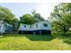 View of the side and back of the house from the yard, showing trees at 1411 Caldwell St, Gastonia, NC 28052
