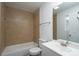 Tiled bathroom with shower-tub, toilet, and sink with mirror at 1411 Caldwell St, Gastonia, NC 28052