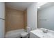 Tiled bathroom with shower-tub, toilet, and sink with mirror at 1411 Caldwell St, Gastonia, NC 28052
