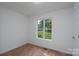 Bright bedroom with a window view of greenery and neutral carpet at 1411 Caldwell St, Gastonia, NC 28052
