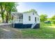 View of the back of the house with access steps to the covered porch, with newly installed grass at 1411 Caldwell St, Gastonia, NC 28052