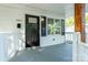 Close-up of the front porch, showcasing wooden columns, white railings, and a black front door at 1411 Caldwell St, Gastonia, NC 28052