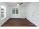 Bright and airy living room with wood floors, white wainscoting, and lots of natural light at 1411 Caldwell St, Gastonia, NC 28052