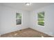 Bedroom with carpet, and two windows at 1411 Caldwell St, Gastonia, NC 28052