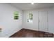 Bright room featuring dark wood flooring, white walls, and two windows for natural light at 1411 Caldwell St, Gastonia, NC 28052