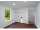 Bright room with wood flooring, window, and closet with wire shelving at 1411 Caldwell St, Gastonia, NC 28052