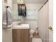 Cozy bathroom with modern vanity and tile flooring, complemented by natural light from the window at 145 Driftwood Dr, Mooresville, NC 28117