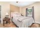 Comfortable bedroom with a plush bed, wood floors, and natural light from the window at 145 Driftwood Dr, Mooresville, NC 28117