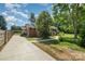 Brick home showcasing an expansive driveway and well-maintained yard at 145 Driftwood Dr, Mooresville, NC 28117