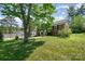 Well-maintained brick home with a lush, green lawn and mature trees at 145 Driftwood Dr, Mooresville, NC 28117