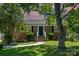 Charming brick home with a manicured lawn and mature trees at sunset at 145 Driftwood Dr, Mooresville, NC 28117