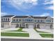 Charming townhome exteriors feature varied colors, one car garages, and well maintained lawns with inviting entryways at 1656 Respect Nw St, Concord, NC 28027