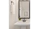 Stylish powder room featuring a modern pedestal sink and decorative mirror at 1837 Bear St, Charlotte, NC 28214