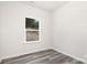 Bright bedroom featuring stylish gray laminate flooring and a large window with wooded views at 1837 Bear St, Charlotte, NC 28214