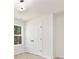 Well-lit bedroom with soft carpet, closet and a window framing outdoor scenery at 1837 Bear St, Charlotte, NC 28214