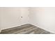 Neutral bedroom showcasing gray laminate flooring and a white paneled door at 1837 Bear St, Charlotte, NC 28214