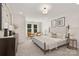 Serene main bedroom featuring soft neutral tones and large windows for natural light at 1837 Bear St, Charlotte, NC 28214