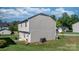 Backyard view of the home featuring a small patio with outdoor seating and a spacious lawn at 1925 Maius Dr # 30, Conover, NC 28613