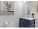 Stylish powder room with a blue vanity, quartz countertop, gold fixtures, and decorative accents at 1925 Maius Dr # 30, Conover, NC 28613