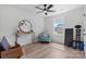 Bright bedroom features light wood floors, a modern ceiling fan, and a cozy seating area near a window at 1925 Maius Dr # 30, Conover, NC 28613