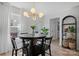 Bright dining area featuring a modern light fixture, black table and chairs, and wood-look flooring at 1925 Maius Dr # 30, Conover, NC 28613