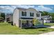Two-story home featuring a front porch with chairs, a pink front door with a wreath, and landscaped yard at 1925 Maius Dr # 30, Conover, NC 28613