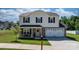 Charming home featuring a front porch with chairs, a pink front door with a green wreath, and manicured lawn at 1925 Maius Dr # 30, Conover, NC 28613