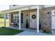 Cozy front porch with seating, complemented by a pink door adorned with a wreath and decorative plants at 1925 Maius Dr # 30, Conover, NC 28613