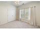 Bright bedroom featuring a ceiling fan, closet, and window with white shutters and curtains at 1929 Faison Ave, Fort Mill, SC 29708