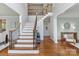 Grand foyer featuring hardwood floors, a staircase with iron railings, and elegant decor at 1929 Faison Ave, Fort Mill, SC 29708