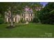 Beautiful brick home with a well-manicured lawn, mature trees, and dark shutters at 1929 Faison Ave, Fort Mill, SC 29708