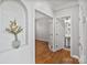 Hallway featuring a decorative niche, hardwood flooring, and access to a half bath at 1929 Faison Ave, Fort Mill, SC 29708