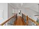 Hallway features hardwood flooring and a decorative wooden banister at 1929 Faison Ave, Fort Mill, SC 29708