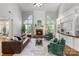 Bright living room with fireplace, custom built-ins, and large arch windows at 1929 Faison Ave, Fort Mill, SC 29708
