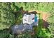 An aerial view of a home nestled in the woods, featuring a pool and long driveway at 1956 Forest Ridge Dr, Stanley, NC 28164