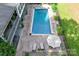 Aerial view showcasing the pool, patio, and surrounding landscaping at 1956 Forest Ridge Dr, Stanley, NC 28164
