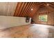 Unfinished attic with exposed rafters and plywood flooring offers renovation potential at 1956 Forest Ridge Dr, Stanley, NC 28164