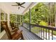 Inviting screened-in porch with rocking chairs overlooking the pool and wooded backyard at 1956 Forest Ridge Dr, Stanley, NC 28164